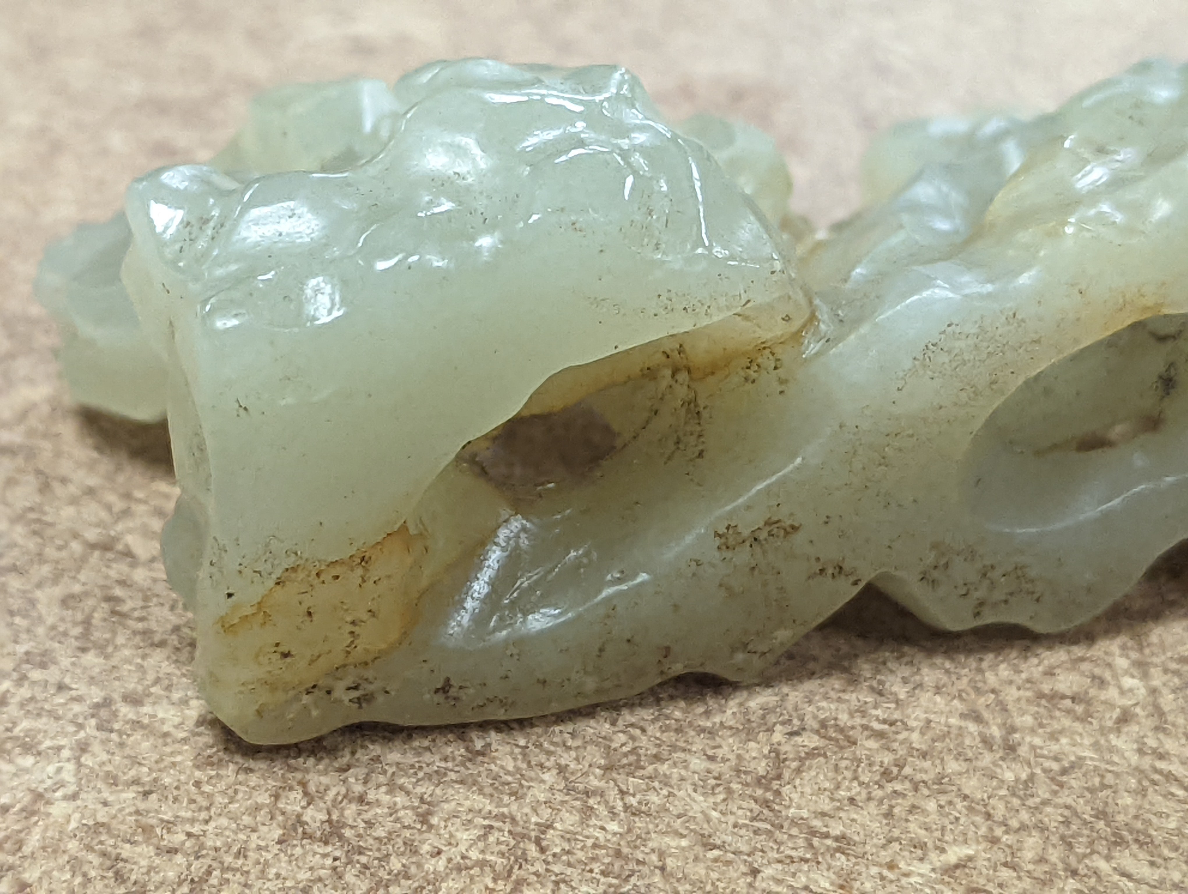 A Chinese celadon jade brush rest, 8cms wide